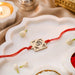 Om Square Brass Rakhi With Golden Finish Gift Set
