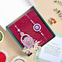 Purple Pearl Beaded Rakhi With Floral Lumba For Couples
