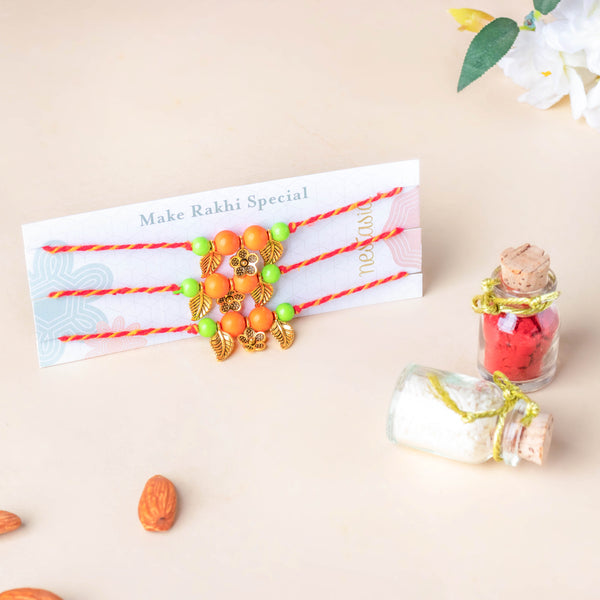 Eclectic Orange And Green Floral Rakhi Set of 3 With Rice Roli
